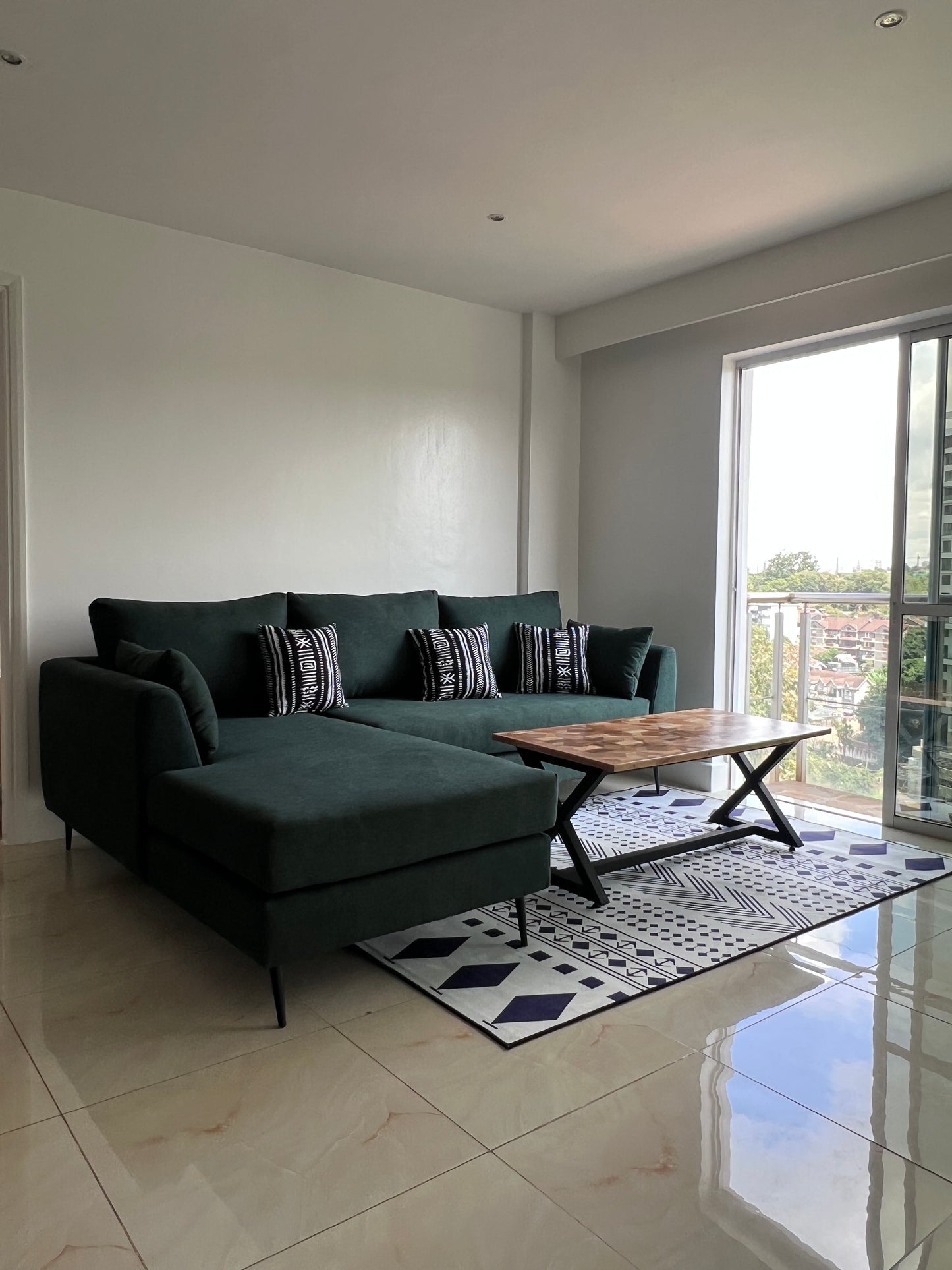 Green L-shape sofa for ksh 90,000 with 40 D cushions