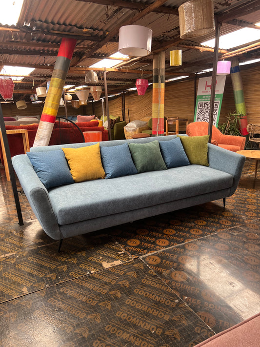 Blue 3 seater sofa with multi-colour throw pillows for ksh 55,000