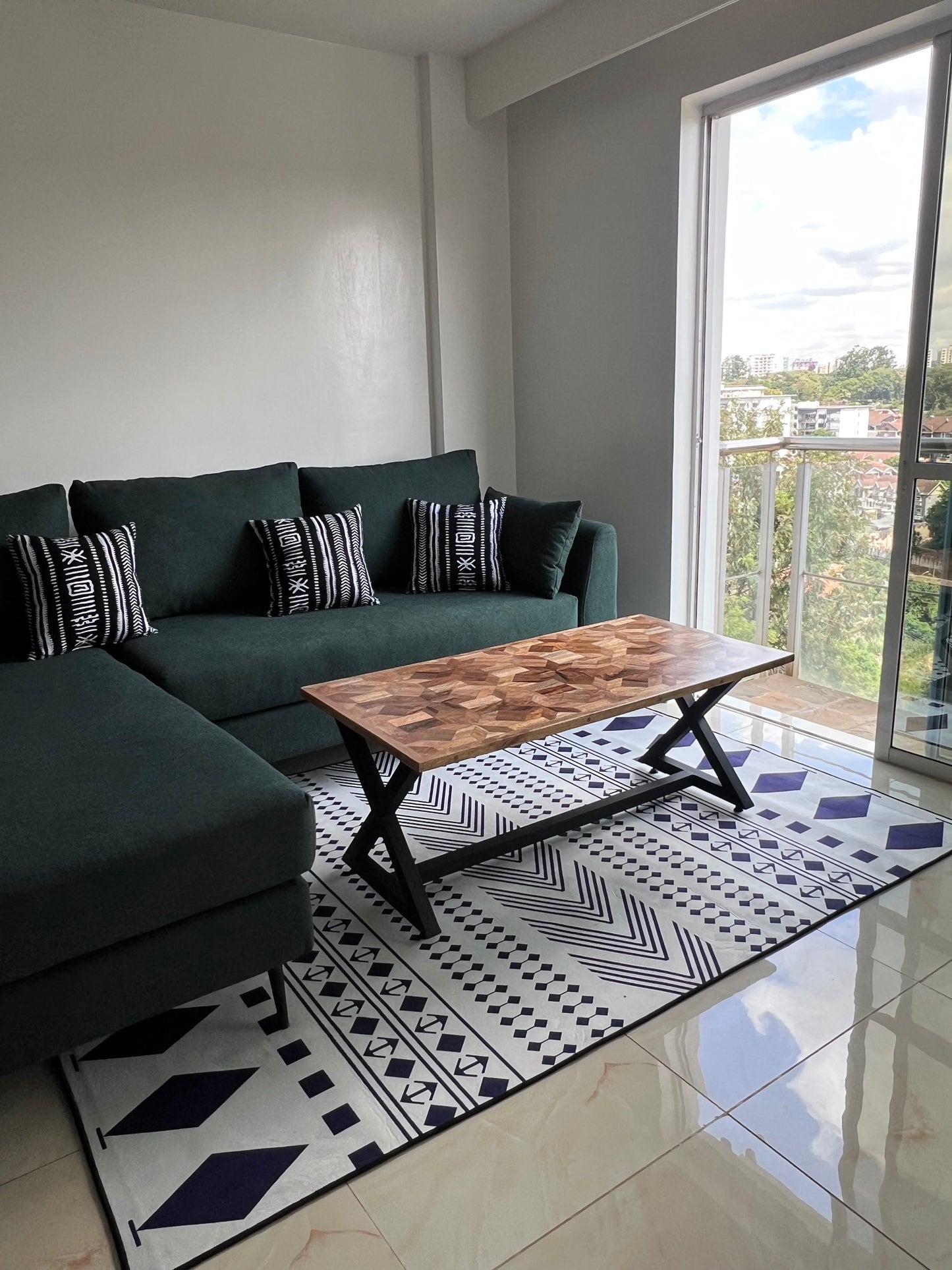 Green L-shape sofa for ksh 90,000 with 40 D cushions