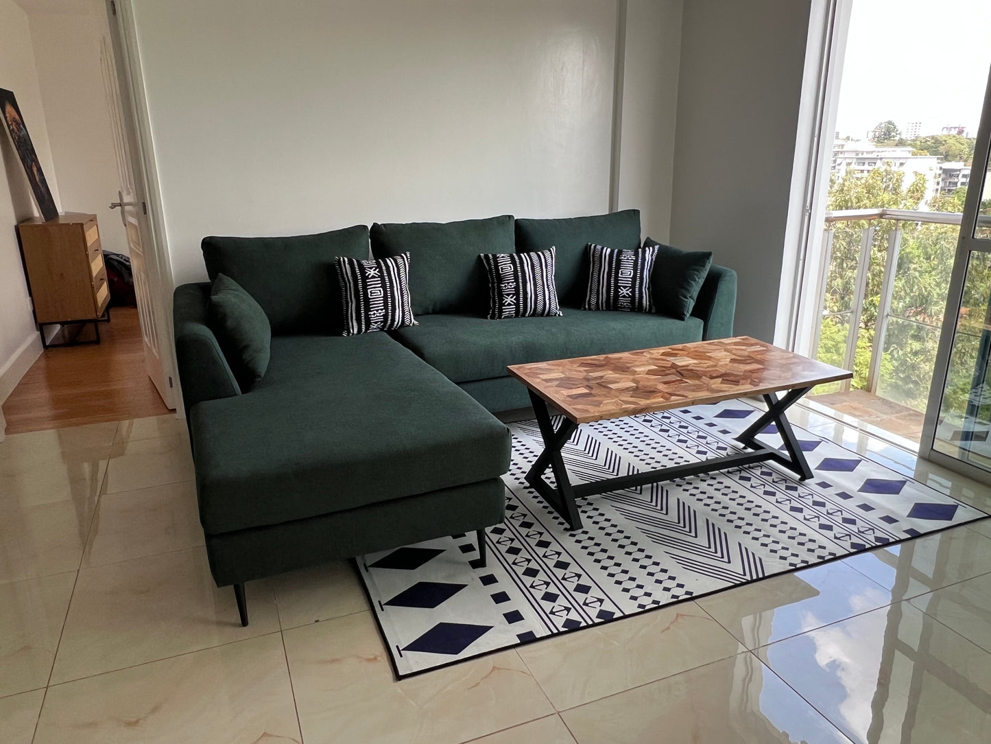 Green L-shape sofa for ksh 90,000 with 40 D cushions