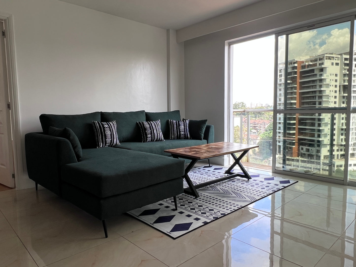 Green L-shape sofa for ksh 90,000 with 40 D cushions