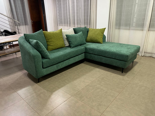 Green l-shape sofa with extra throw pillows