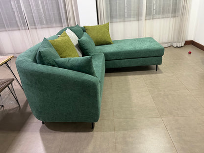 Green l-shape sofa with extra throw pillows