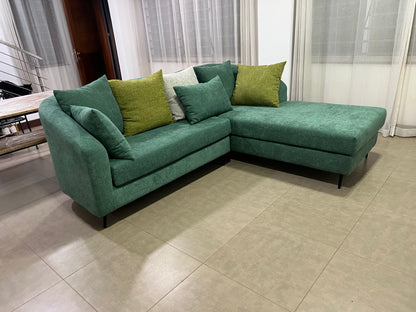 Green l-shape sofa with extra throw pillows