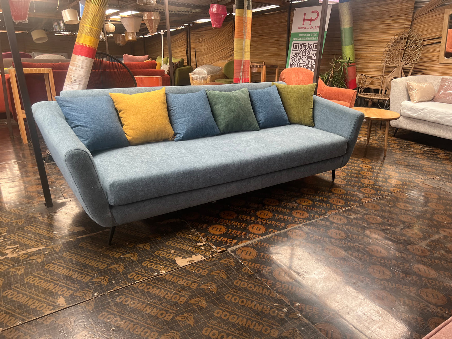 Blue 3 seater sofa with multi-colour throw pillows for ksh 55,000